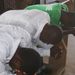 3 young men praying at the conference.