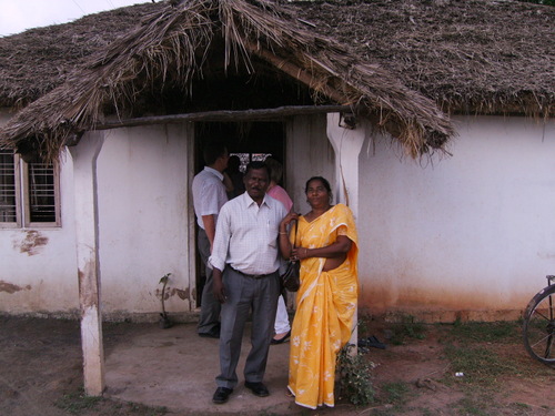 Victor and wife outside his church.