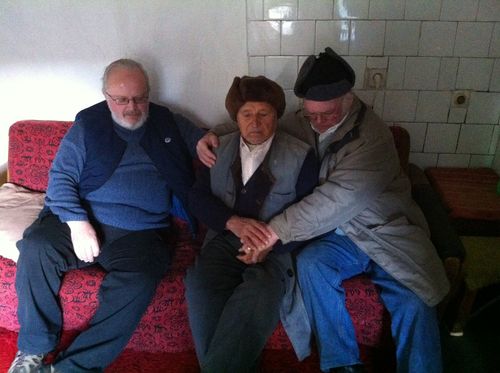 Arthur and Brian praying with an elderly member of the church
